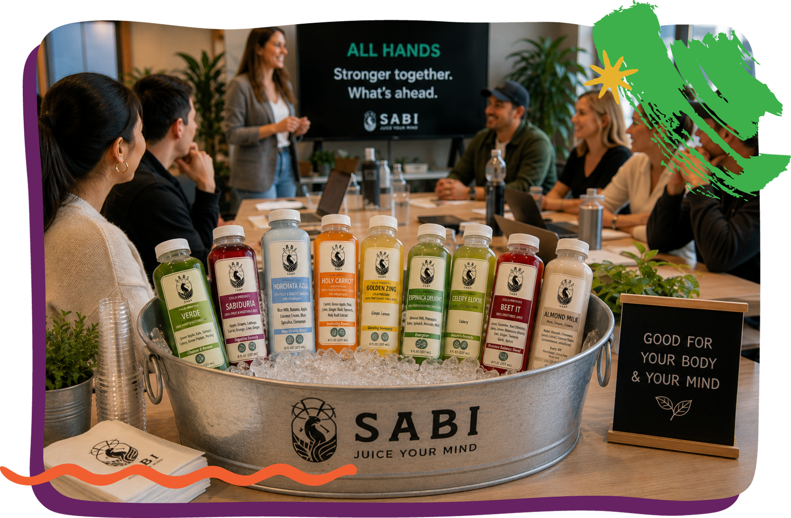 A working meeting happening with a iced tub of Sabi Juice in the front.
